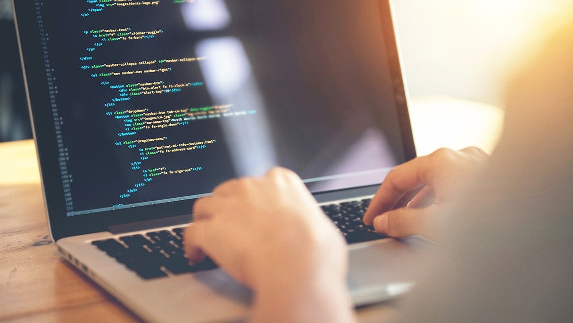 close up of a laptop screen showing coding