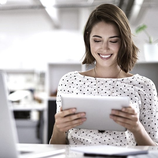 woman looking into a tablet