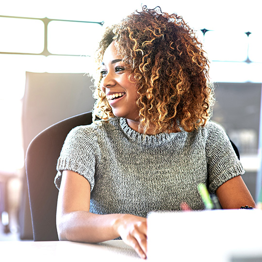 woman smiling and working