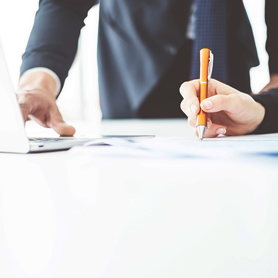 man signing documents