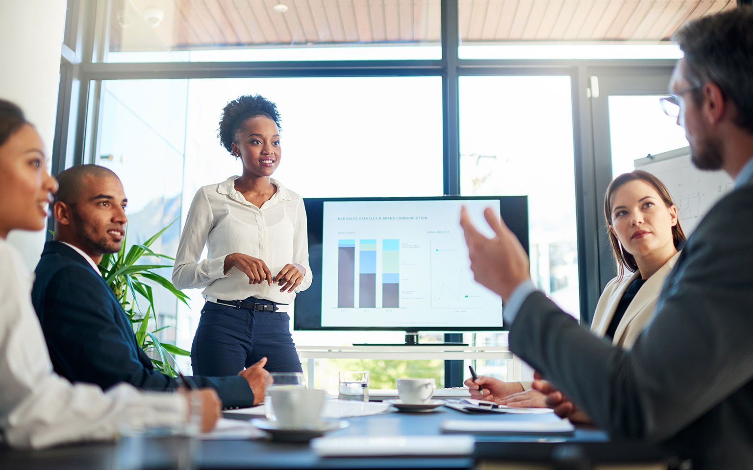 employees looking at a tablet in a meeting