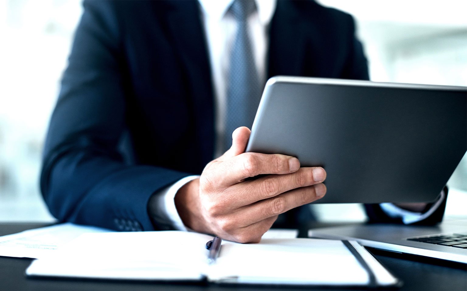 close up of hand pointing at tablet