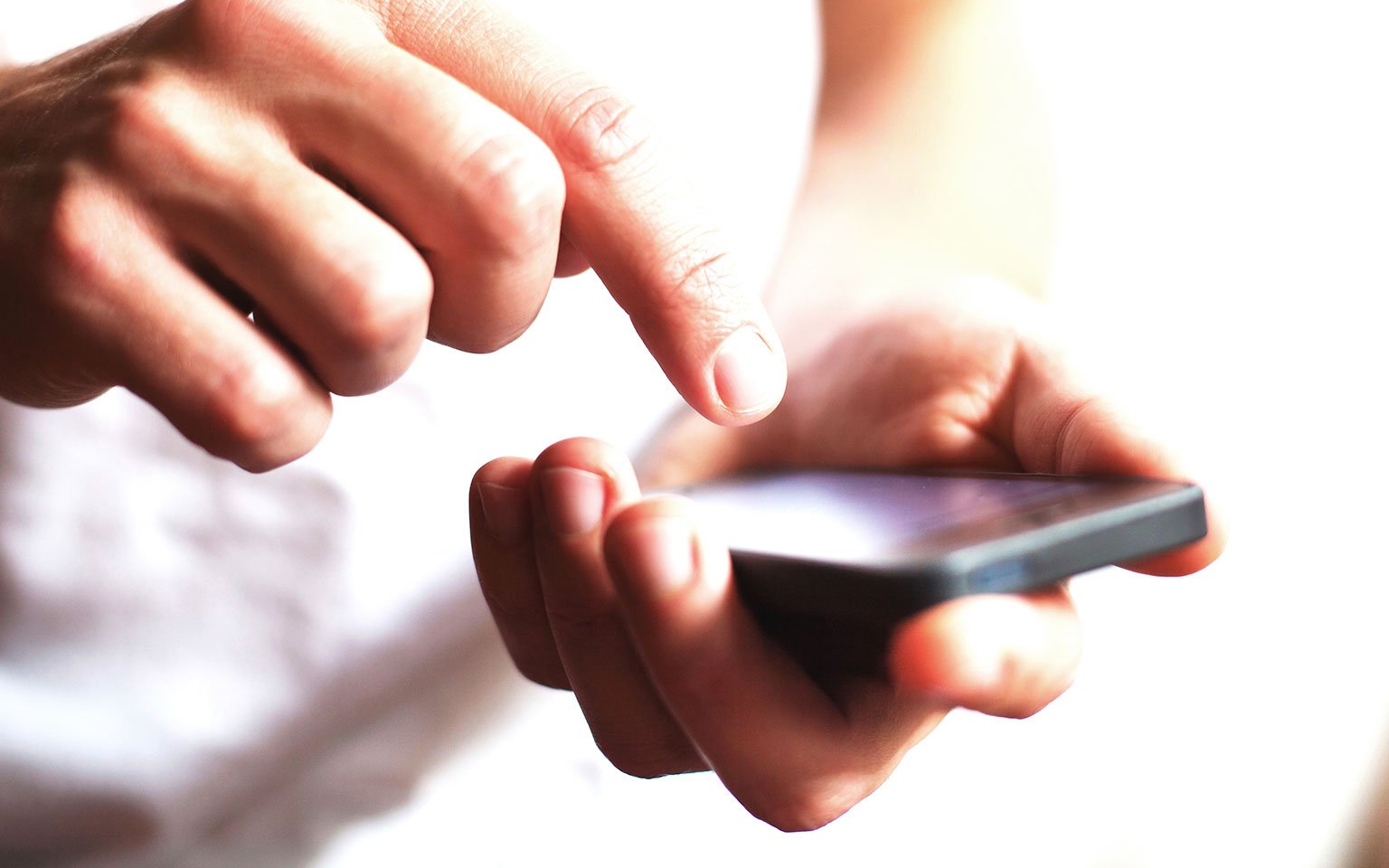 close up of hands typing on a smartphone